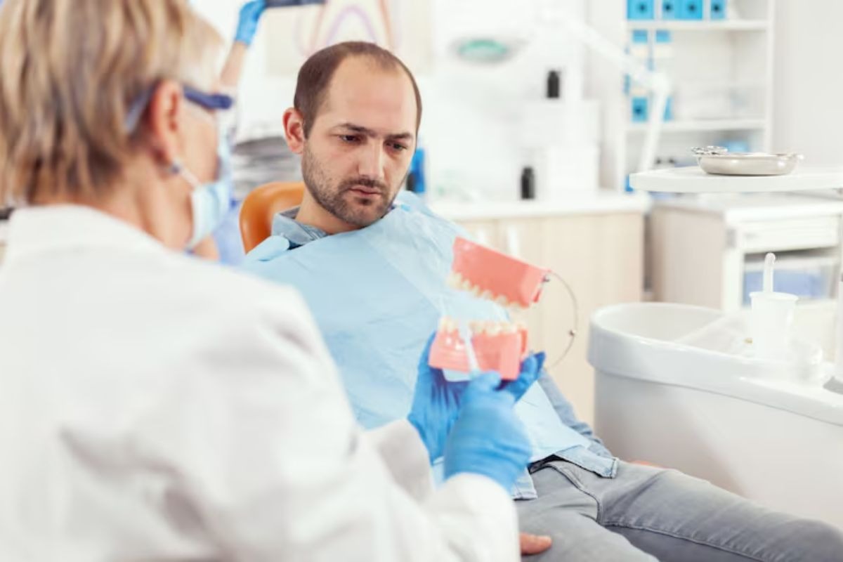 dental bridge consultation with a dentist explaining tooth replacement options to a patient.