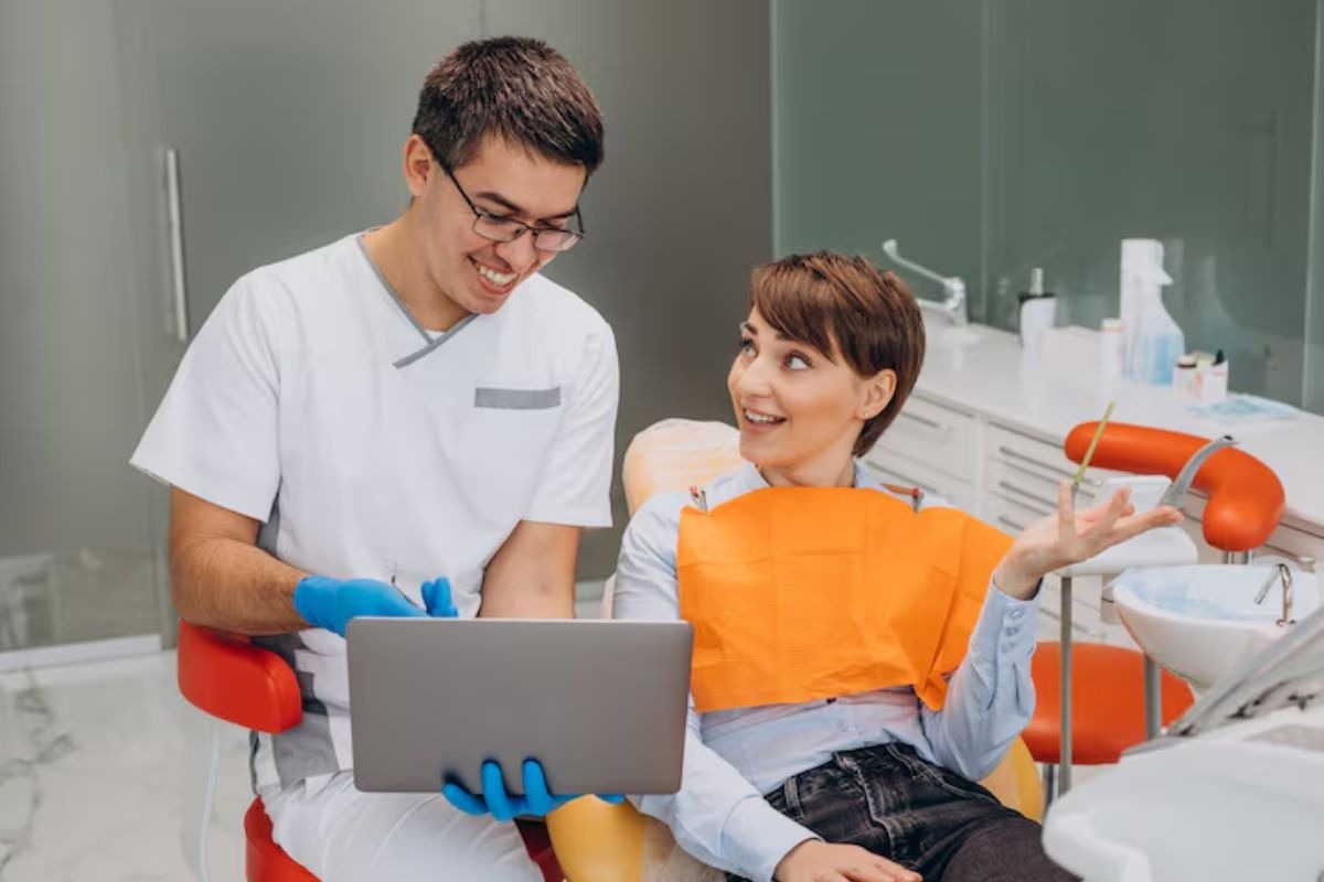 dentist discussing oral health with a patient during a dental visit.